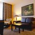 Sana Silver Coast Hotel in Caldas da Rainha living room with leather sofa, coffee table and armchair