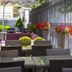Sana Silver Coast Hotel in Caldas da Rainha outdoor terrace with wicker tables, chairs and flower planters