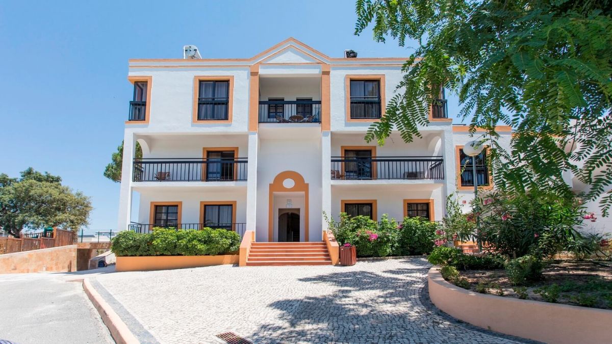 Alfagar Village in Albufeira, white three-story hotel exterior with balconies and central entrance