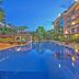Hotel Somadevi Angkor Resort & Spa in Siem Reap with a lit outdoor pool at dusk