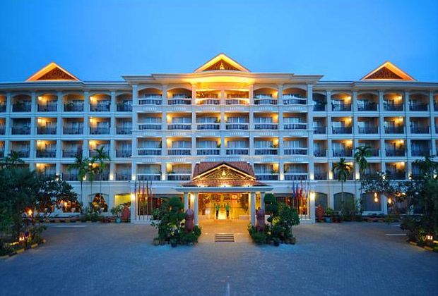Hotel Somadevi Angkor Resort & Spa in Siem Reap, a grand illuminated hotel facade at dusk