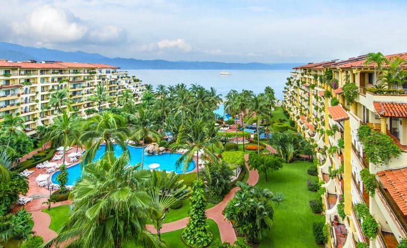 Velas Vallarta in Puerto Vallarta with tropical gardens, pools, and ocean views between resort buildings