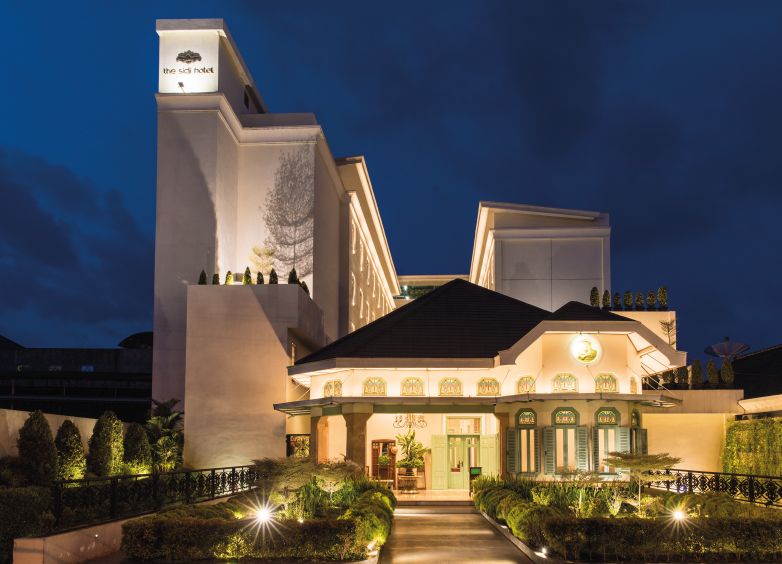 The Sidji Hotel in Pekalongan exterior at dusk with illuminated facade and landscaped entrance