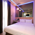 Check Inn Express Taichung Fuxing Hall 2 bedroom with bed, mirror wall and blue LED ceiling lights in Taichung City
