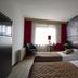 Bastion Hotel Barendrecht room with twin beds, desk by window, and black-and-white harbor wall mural