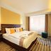 Hotel Duo & Wellness Prague guest room with king bed, wall-mounted TV, and large window with curtains