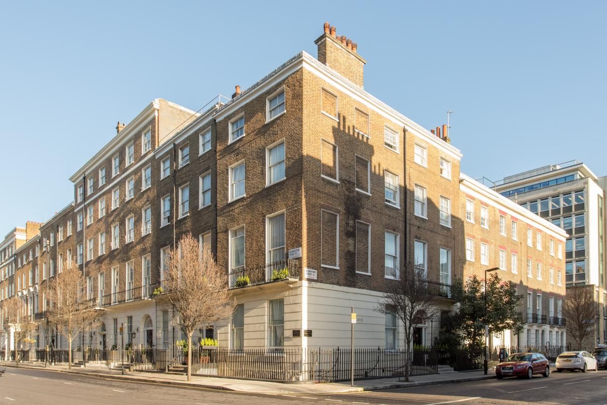 Amber Residence Hotel in London, exterior of a corner brick hotel building on a city street