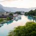 The River Village in Interlaken with riverboats on a turquoise river and mountain views