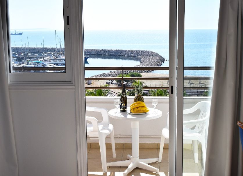 Sun Hall Beach Hotel Apartments in Larnaca, balcony with table, chairs and sea view over marina
