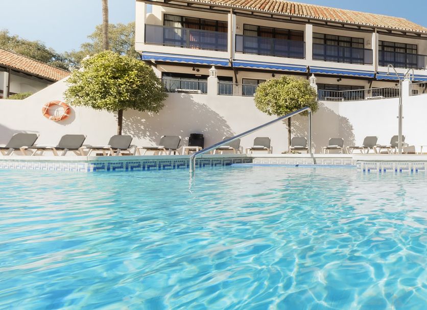 Ona Diana Park in Estepona with a bright outdoor pool and sun loungers by the water