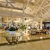 Bahia Principe Explore La Romana lobby with glass table, lounge seating and high vaulted ceiling