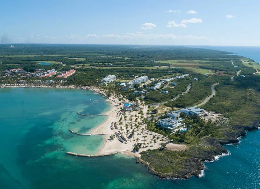 Bahia Principe Explore La Romana - All Inclusive aerial view of beachfront cove and coastal cliffs in La Romana