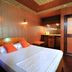 Frendz Hostel Boracay in Boracay room with double bed, wood-paneled walls and small vanity area