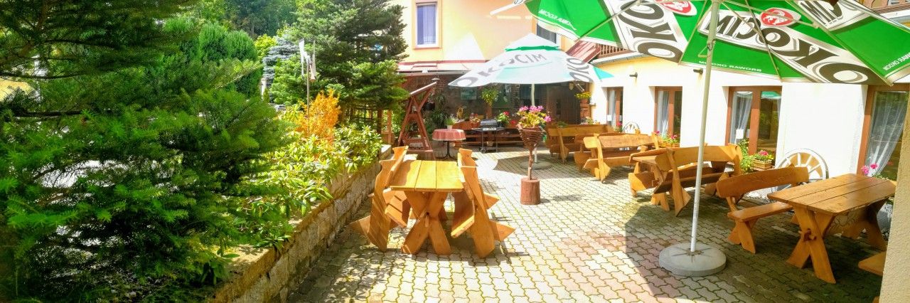 Rezydencja Pod Szczytami in Szklarska Poręba, outdoor patio with wooden tables and umbrellas