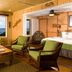 Hana Kai Maui in Hana: ocean-view room with chairs, table, and large windows overlooking the water
