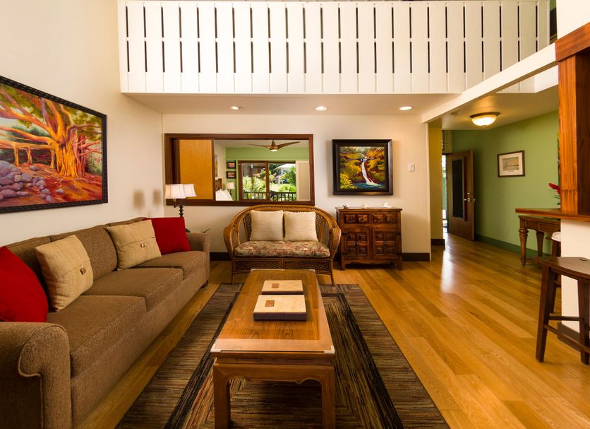 Hana Kai Maui in Hana: bright suite with sofa, coffee table, wood floors and vaulted ceiling