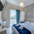 Argyro Rent Rooms in Kritsa guest room with bed, balcony door, and mountain view