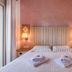Argyro Rent Rooms in Kritsa bedroom with double bed, bedside lamps, and wardrobe