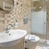 Argyro Rent Rooms in Kritsa bathroom with sink, toilet and glass shower enclosure
