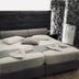 Villa Livadaros in Thera: double bed with dark headboard, side tables, and patterned wall panels