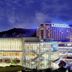 Swiss Grand Hotel in Seoul with illuminated glass facade and mountain backdrop at night
