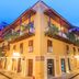 Hotel Boutique Casa del Coliseo in Cartagena, corner facade with balconies and warm-lit street level