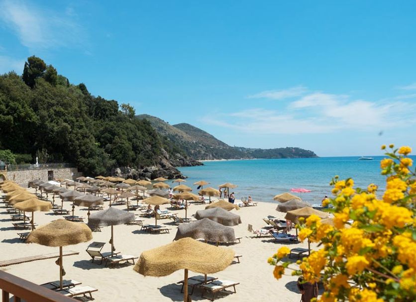 Summit Hotel in Gaeta with private sandy beach, sun loungers and umbrellas beside clear blue sea