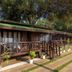 Saffron Stays Little Paradise in Murud, a wooden cottage with porch and steps amid trees