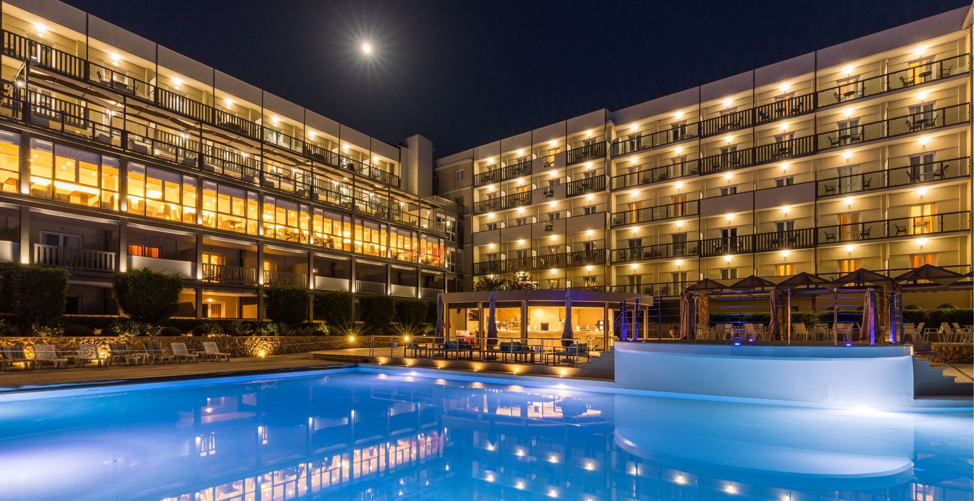 Ariti Grand Hotel Corfu in Kanoni with illuminated pool and lit balcony views at night