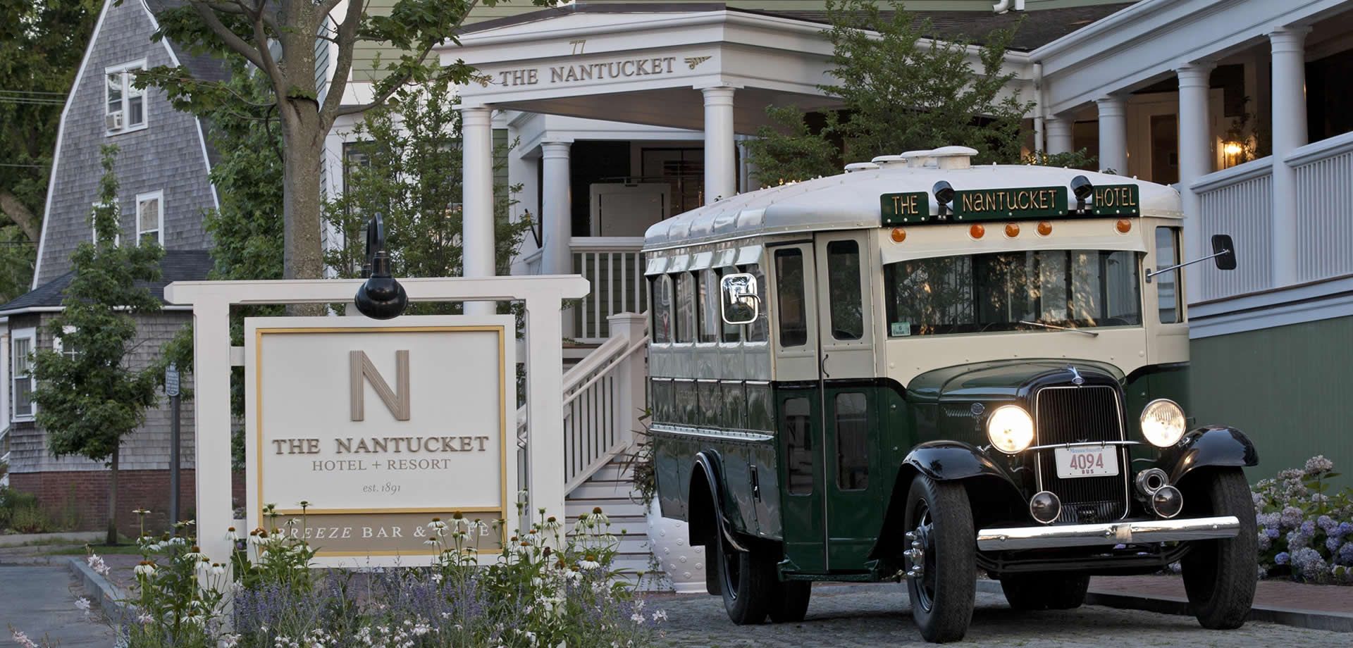 The Nantucket Hotel & Resort in Nantucket with a vintage shuttle parked by the entrance sign.