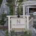 The Nantucket Hotel & Resort in Nantucket with a vintage shuttle parked by the entrance sign.