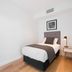 Brisbane Skytower hotel room with single bed, bedside lamp and mirrored wardrobe in Brisbane