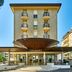 Palace Hotel Regina in Bibione, exterior with curved entrance canopy and balconies