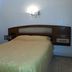 Hotel Isis in Buenos Aires guest room with double bed, wall-mounted light, and simple furnishings