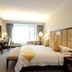 Ocean City in Shenzhen guest room with king bed, desk, bench, and large window seating area