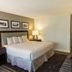 Yavapai Lodge West guest room in Grand Canyon Village with king bed, lamp, and dresser