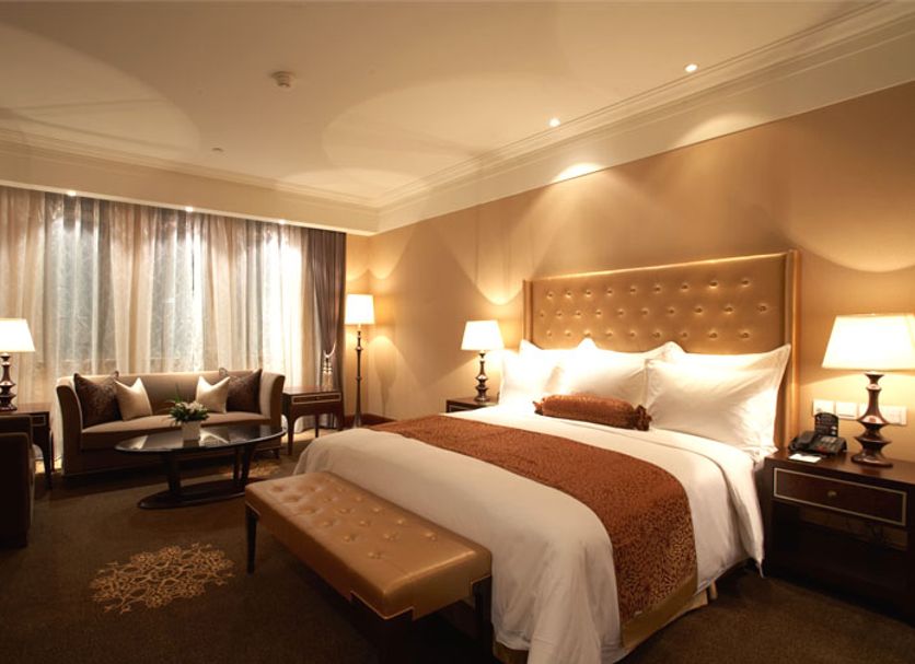 Shanghai Fenyang Garden Boutique Hotel room in Shanghai with king bed, seating area, and warm lighting