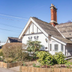 The Manor at Bickley in Bromley, exterior of a white cottage-style hotel building and garden