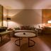 Golden Lake Hotel in Jinhu Township lounge with sofa, armchairs, round coffee table and warm lighting