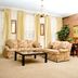 Quarter House Suites in New Orleans living room with sofas, coffee table, chandelier, and brick accent wall