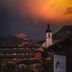 Hotel Zum Ritter in Tannheim with alpine village views and a church tower at sunset