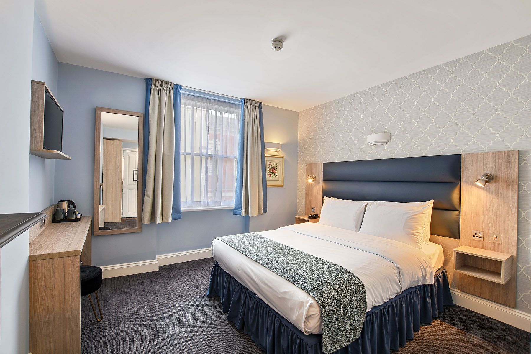 Judd Hotel London guest room with double bed, window, desk and chair