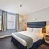 Judd Hotel London guest room with double bed, window, desk and chair