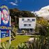 Mousetrap Backpackers in Paihia with tropical garden and palm trees outside the hostel