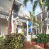 The Palms Hotel in Key West with palm trees, lush landscaping, and a charming porch