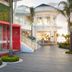 Azul Beach Resort Negril in Negril with tropical walkway and red glass-front dining pavilion