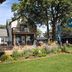 Lakes Inn in Detroit Lakes exterior with balcony, garden landscaping, and sign in front