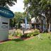 Lakes Inn in Detroit Lakes sign, landscaped lawn, outdoor patio, and lakeside building exterior.