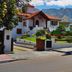 Hosteria de los Cesares in Villa de Merlo, white hillside hotel with mountain backdrop and garden