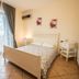 Gambero Nero in Tellaro bedroom with double bed, balcony doors and tiled floor